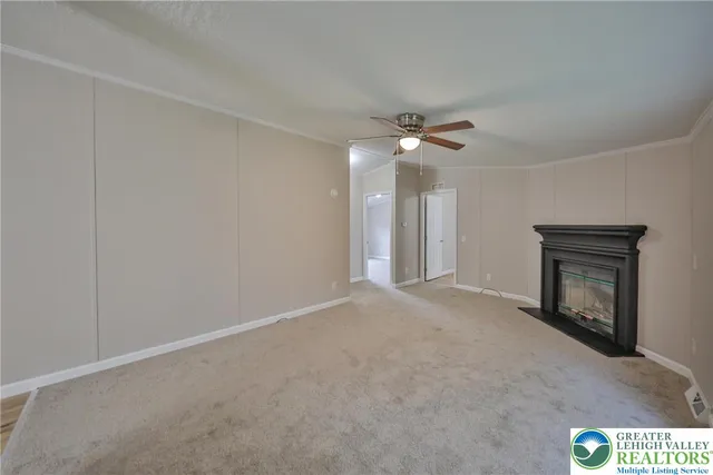 a view of an empty room with a fireplace