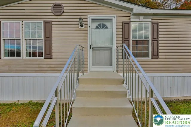 a view of balcony with wooden floor and fence and a window