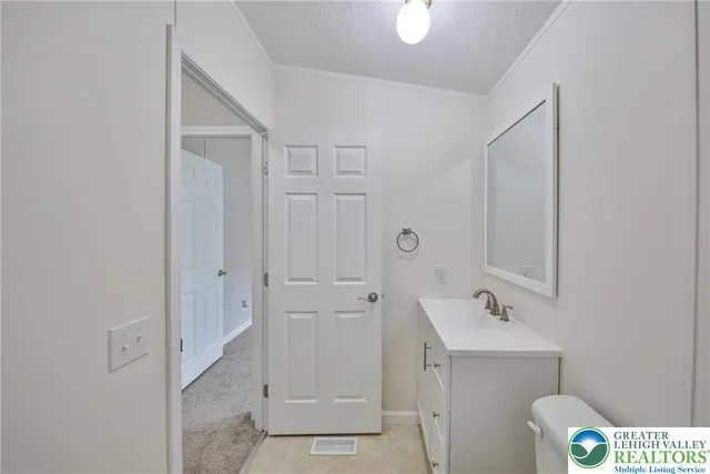 a view of an empty room with a window and a lamp