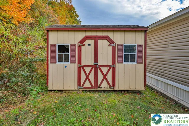 an aerial view of a house with a yard basket ball court and outdoor seating
