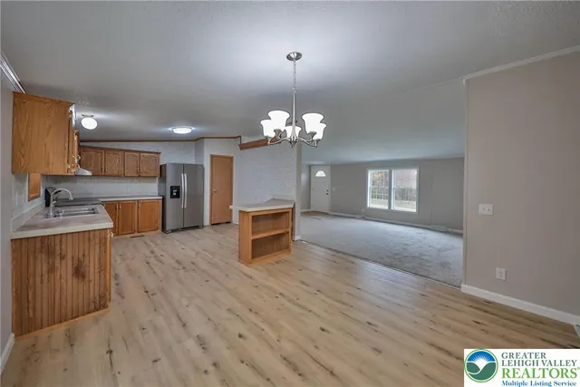 a view of a kitchen with a sink and dishwasher kitchen view with wooden floor