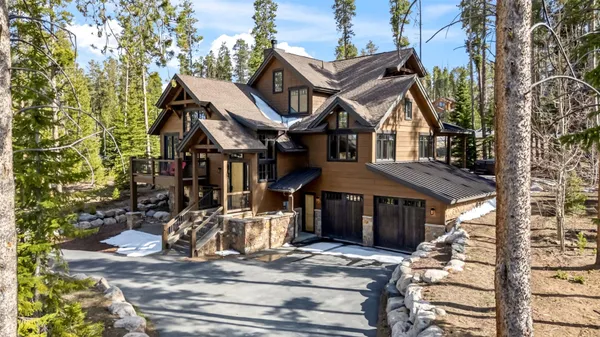 a front view of a house with a tree