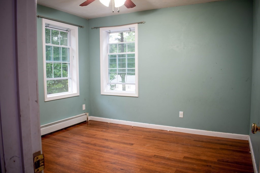 227 Turkey Hill Road Rutland, MA 01543 - Photo 20 of 30 an empty room with wooden floor and windows