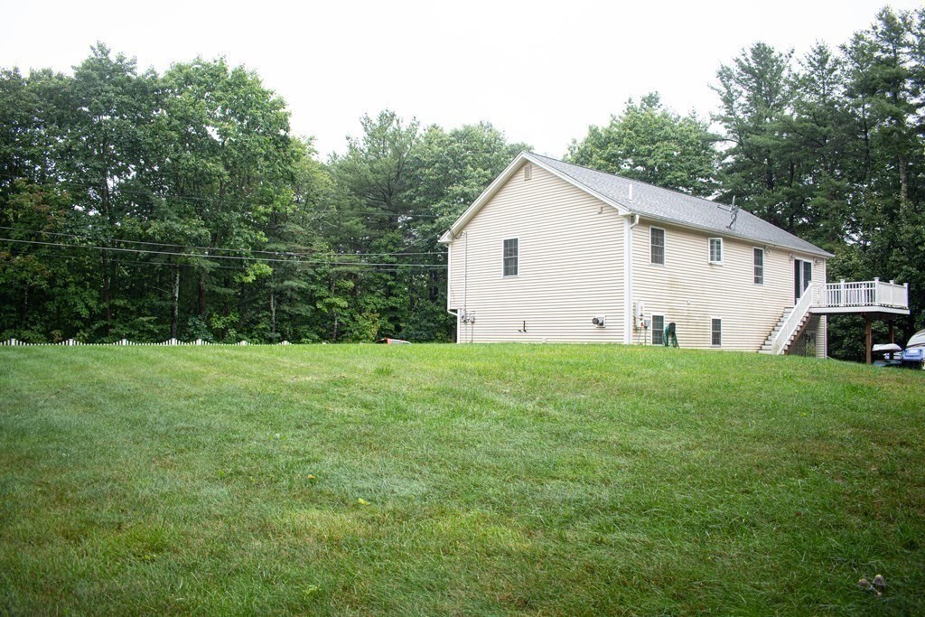 227 Turkey Hill Road Rutland, MA 01543 - Photo 27 of 30 a view of a white house in front of a big yard with large trees