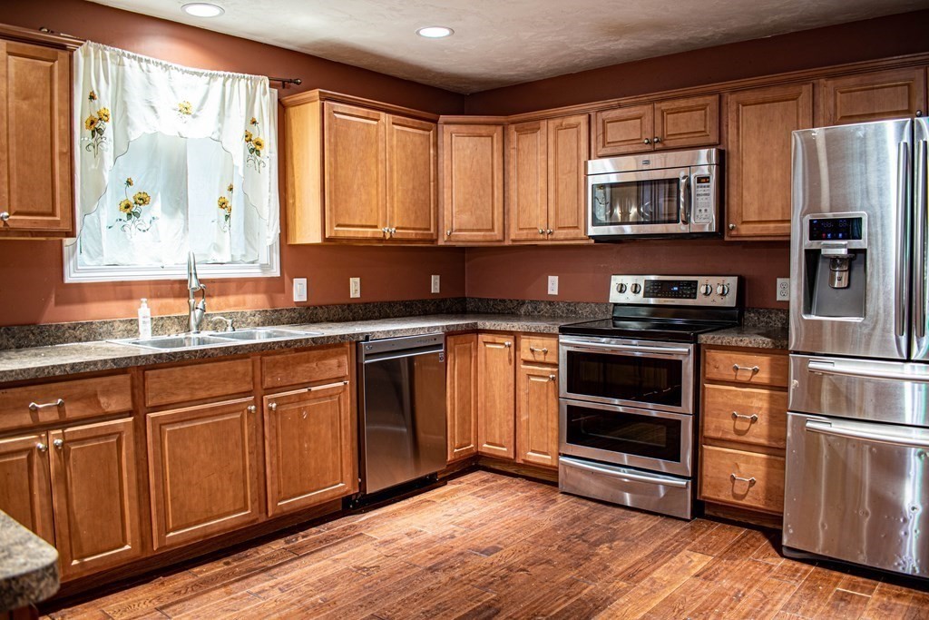 227 Turkey Hill Road Rutland, MA 01543 - Photo 3 of 30 a kitchen with stainless steel appliances granite countertop a stove a sink and a refrigerator