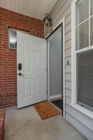 a view of a hallway view with wooden floor and furniture