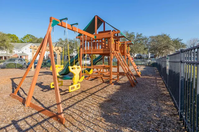 a living room with furniture and a book shelf