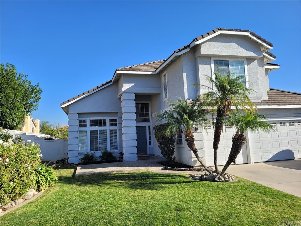 6769 Gilbert Place Rancho Cucamonga, CA 91701 - Photo 1 of 1 a front view of a house with a yard and potted plants