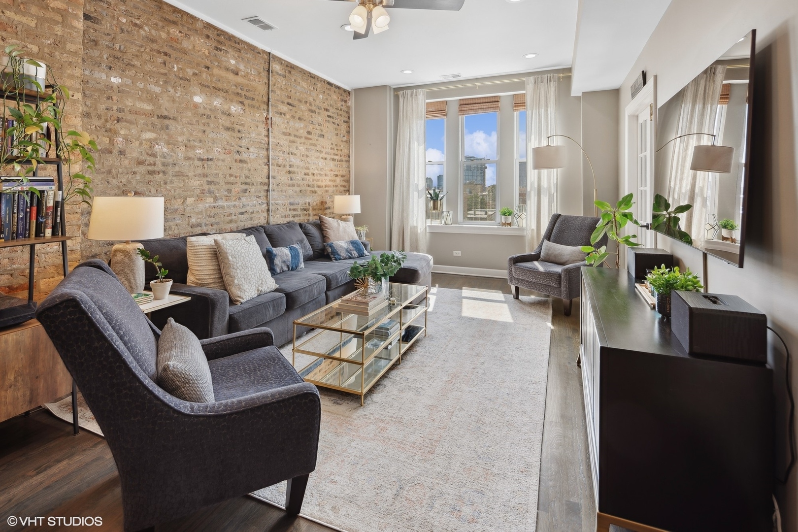 1326 West Huron Street, Unit 4 Chicago, IL 60642 - Photo 2 of 20 a living room with furniture wooden floor and a flat screen tv