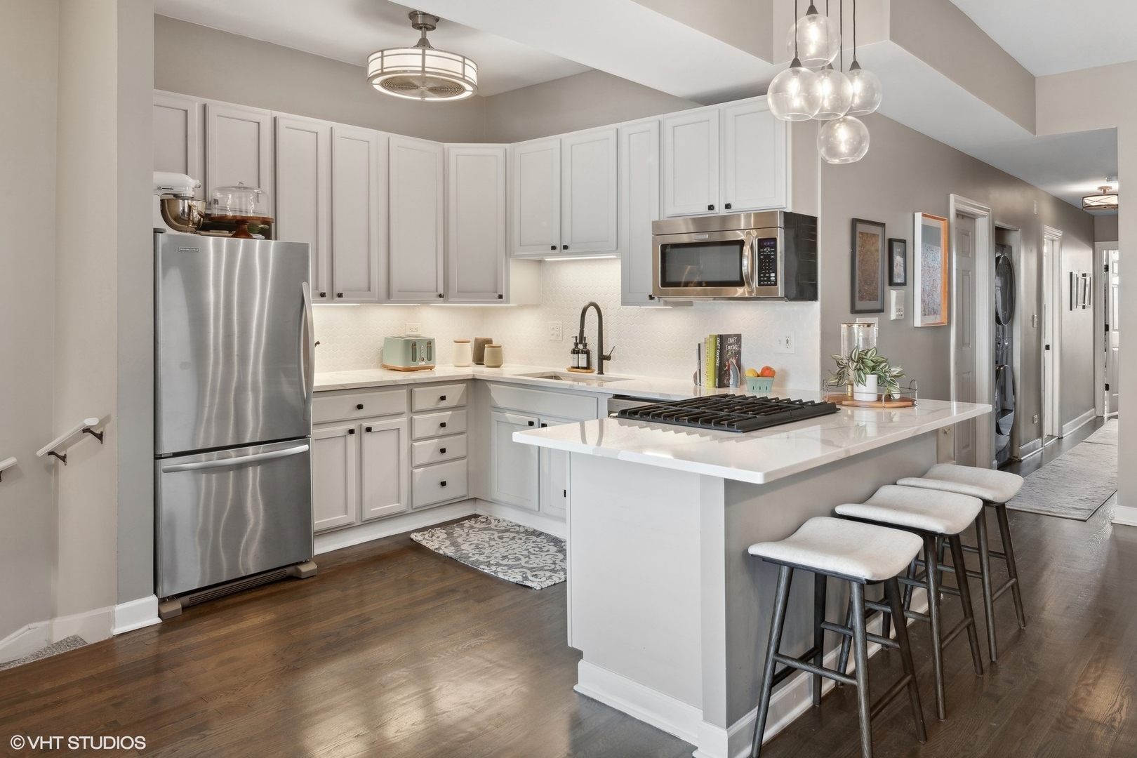 1326 West Huron Street, Unit 4 Chicago, IL 60642 - Photo 4 of 20 a kitchen with stainless steel appliances granite countertop a refrigerator a sink dishwasher a stove and white countertops with wooden floor