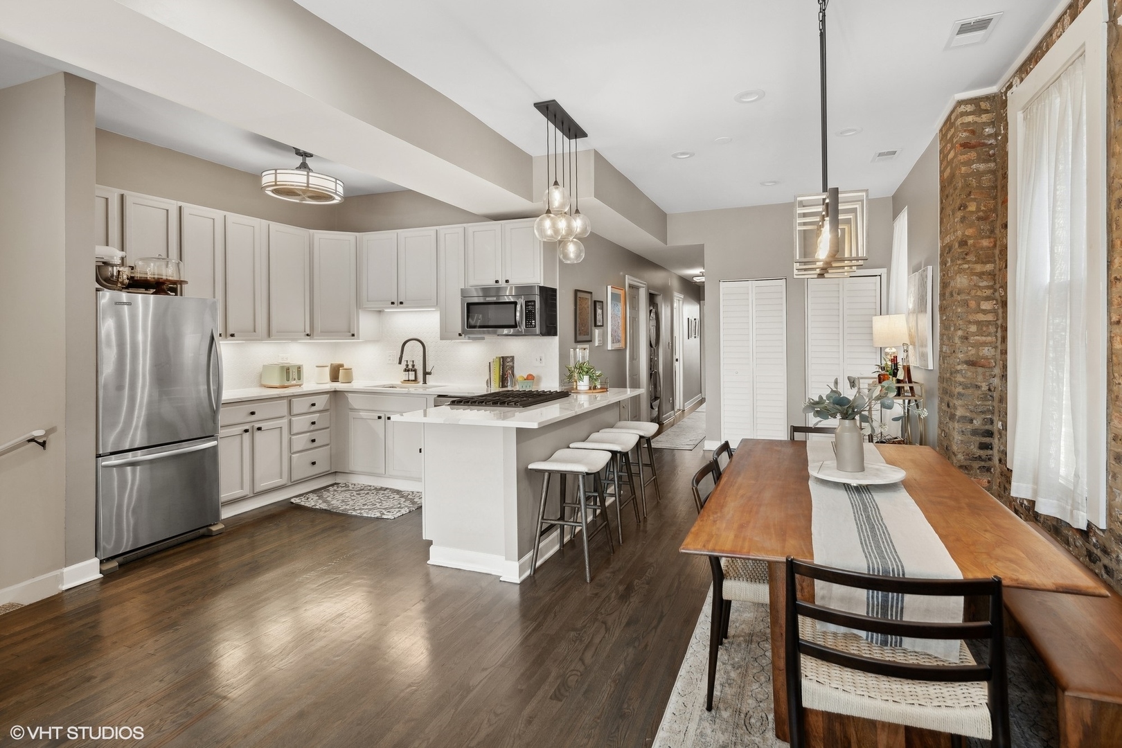 1326 West Huron Street, Unit 4 Chicago, IL 60642 - Photo 8 of 20 a kitchen with refrigerator cabinets and wooden floor