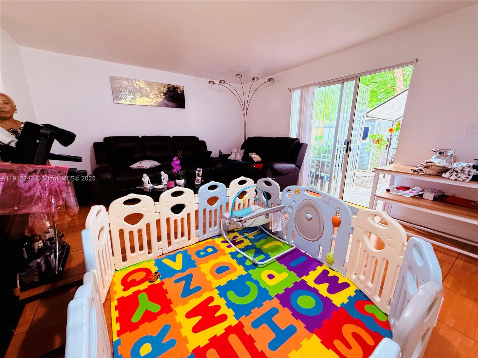 2243 Northwest 135th Terrace, Unit 2243 Opa-Locka, FL 33054 - Photo 11 of 19 a bedroom with bed and a window