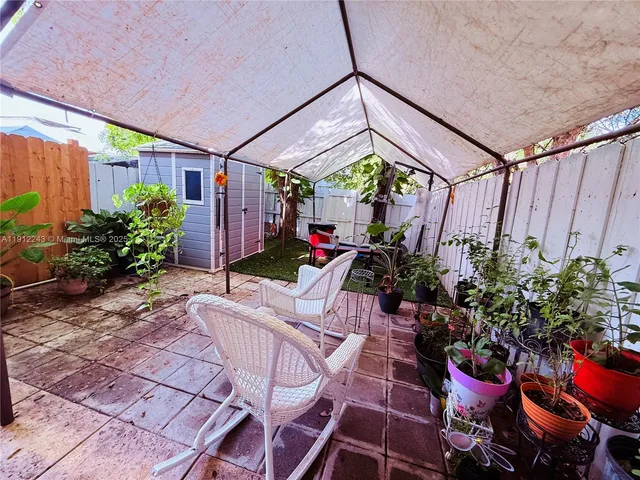 a outdoor space with chairs and potted plants