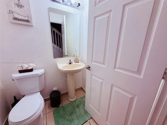 a white toilet sitting next to a bathroom sink