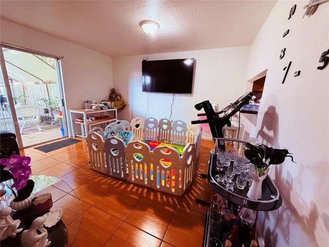 a bedroom with furniture and a flat screen tv