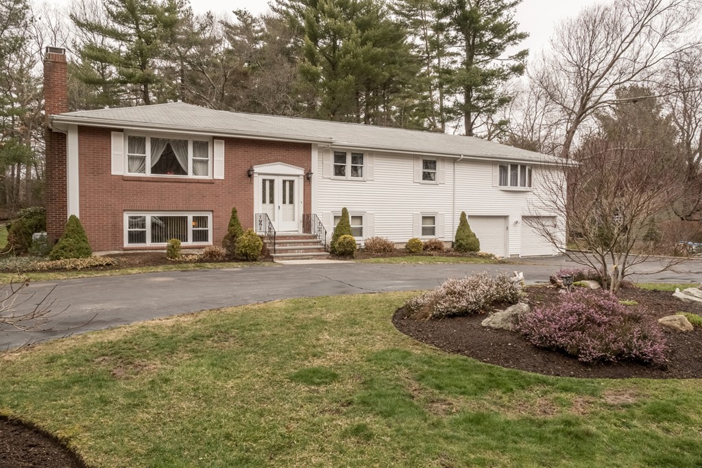 3 Surrey Lane Canton, MA 02021 - Photo 1 of 9 a front view of a house with a yard