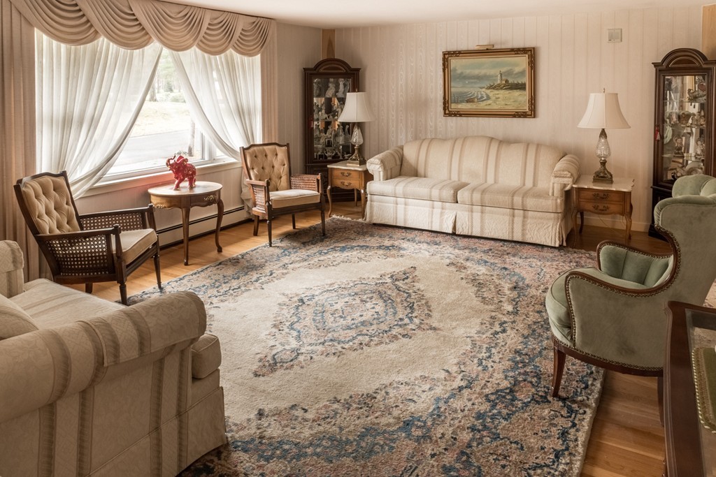 3 Surrey Lane Canton, MA 02021 - Photo 2 of 9 a living room with furniture a rug and a window