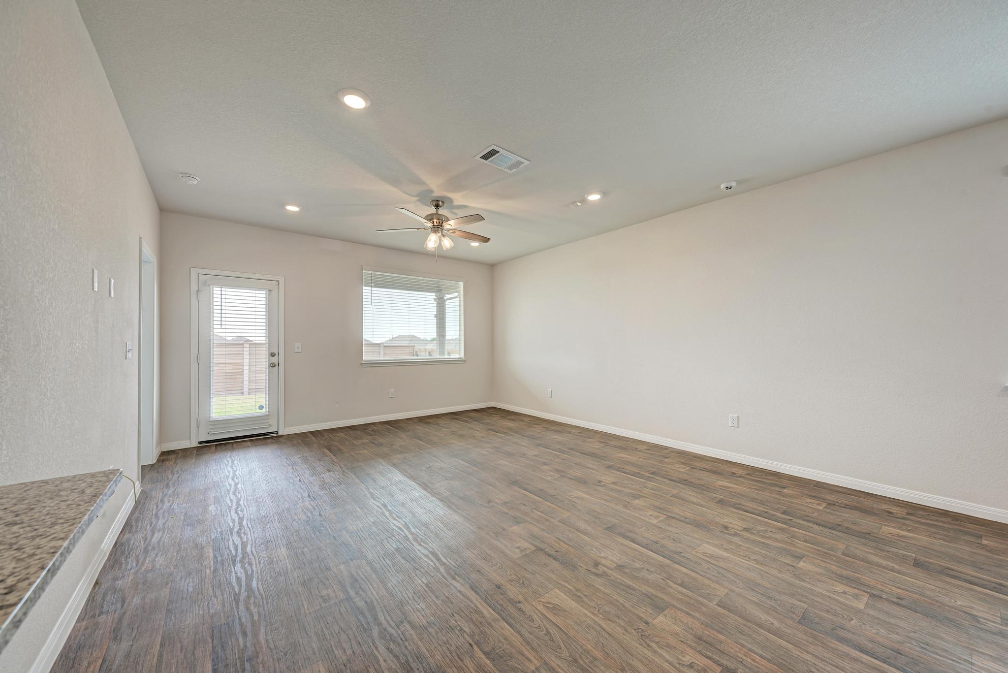 208 Abby Road Georgetown, TX 78626 - Photo 20 of 40 an empty room with wooden floor and windows
