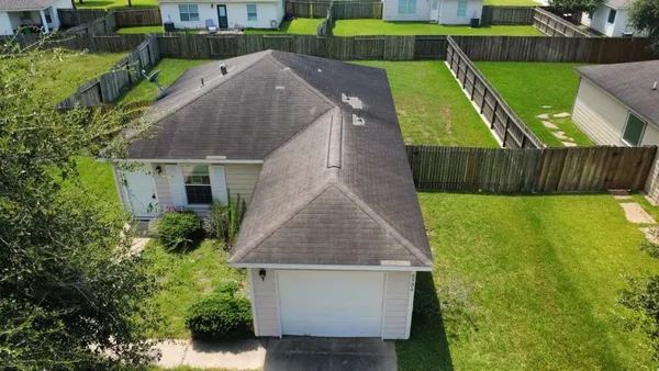 a aerial view of a house with a yard