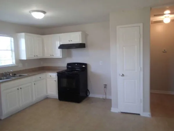 a bedroom with a bed and a lamp