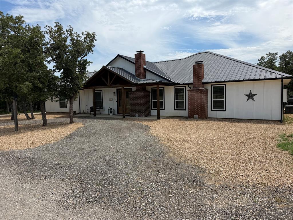 129 Whiskey Rnch Road Runaway Bay, TX 76426 - Photo 2 of 39 a front view of a house with a yard