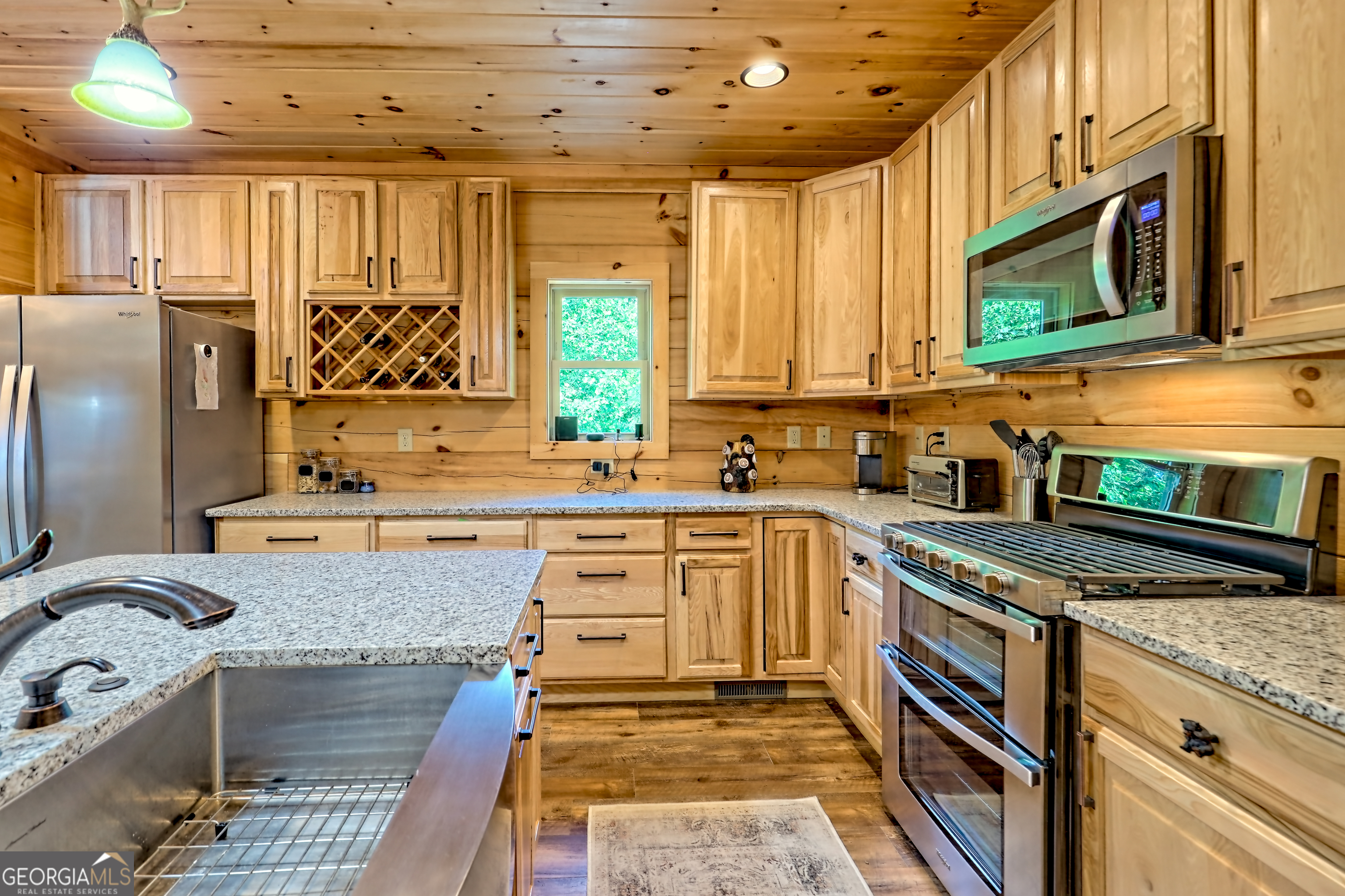 117 Ivy Rdg Way Clarkesville, GA 30523 - Photo 18 of 84 a kitchen with stainless steel appliances granite countertop a stove a sink and a microwave