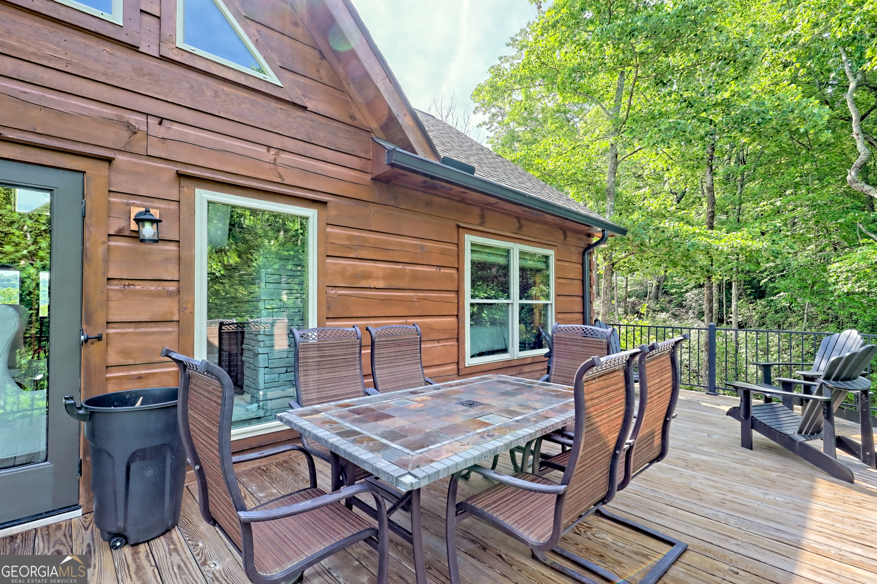 117 Ivy Rdg Way Clarkesville, GA 30523 - Photo 22 of 84 a view of a patio with table and chairs with wooden floor and fence