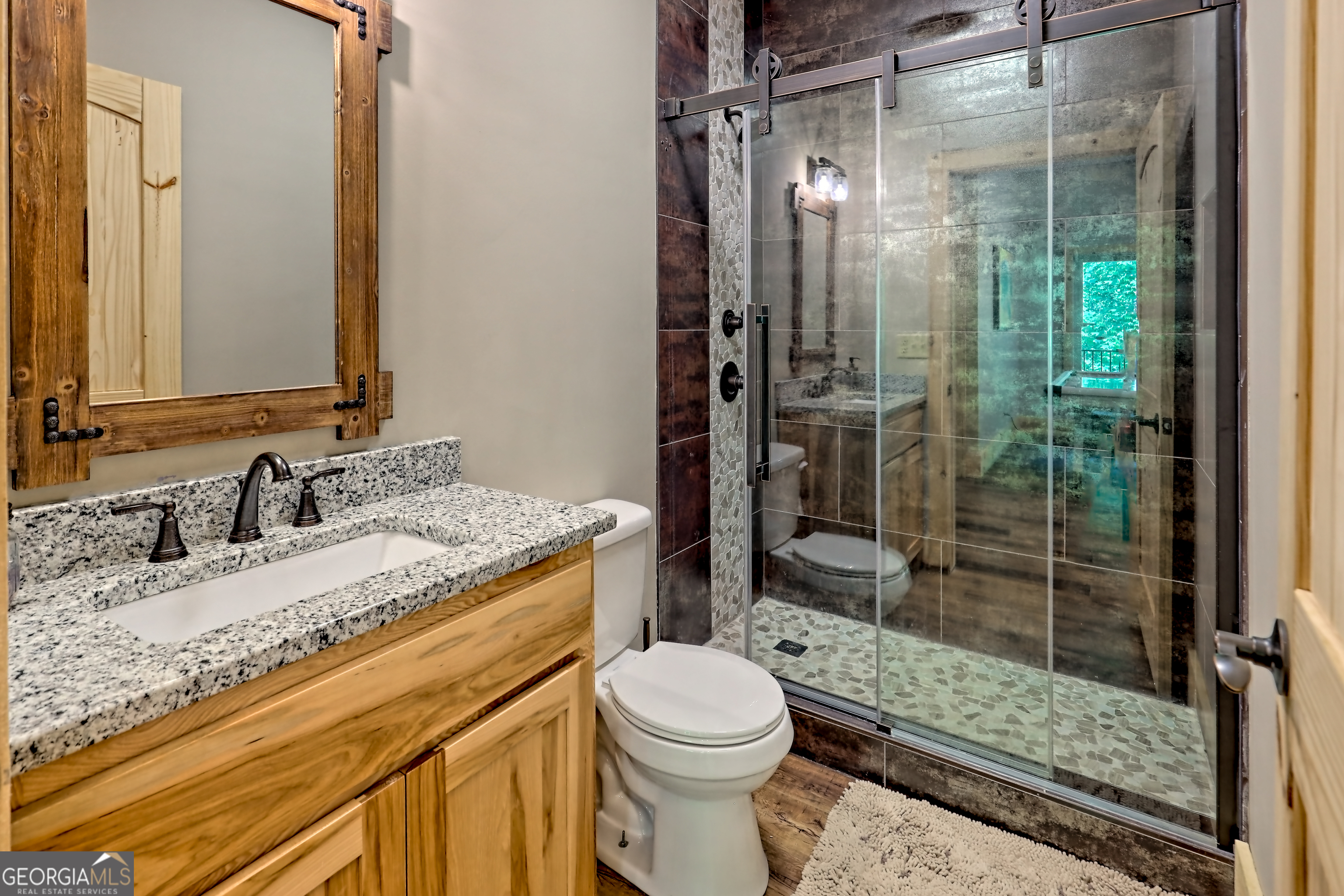 117 Ivy Rdg Way Clarkesville, GA 30523 - Photo 64 of 84 a bathroom with a granite countertop sink toilet and shower
