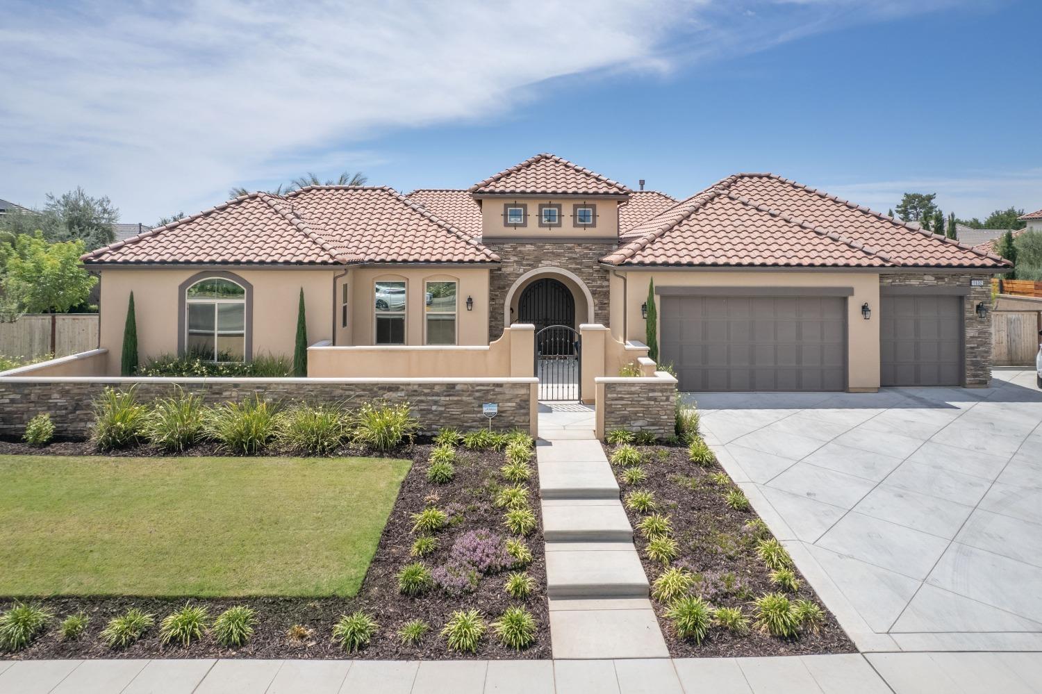 1632 North De Wolf Avenue Clovis, CA 93619 - Photo 1 of 80 a front view of a house with a garden