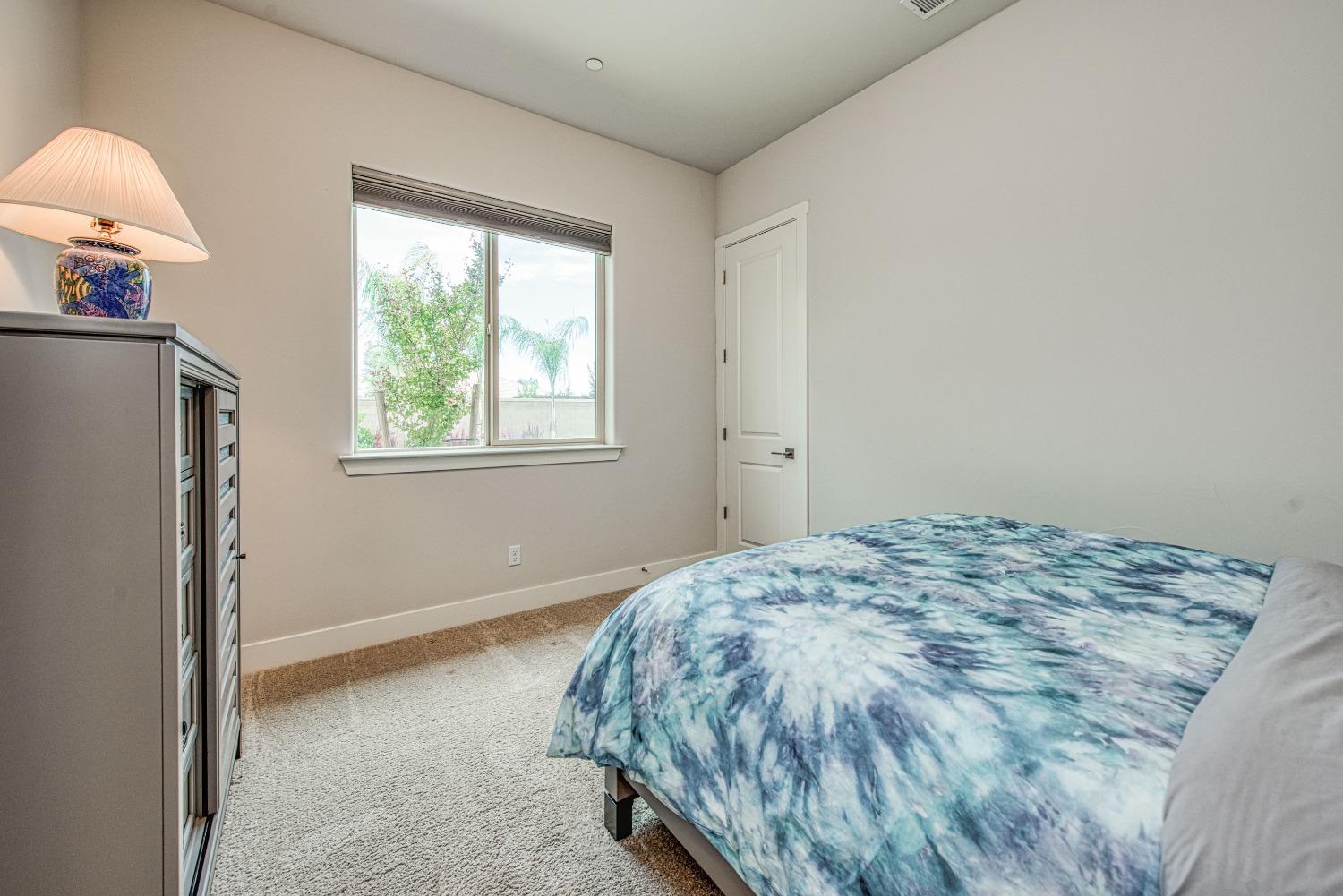 1632 North De Wolf Avenue Clovis, CA 93619 - Photo 19 of 80 a bed sitting in a bedroom next to a window