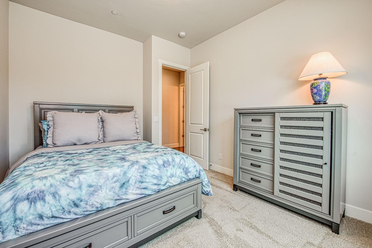 1632 North De Wolf Avenue Clovis, CA 93619 - Photo 20 of 80 a bedroom with a bed and a mirror