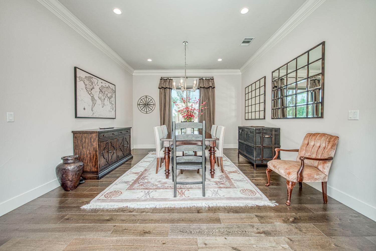 1632 North De Wolf Avenue Clovis, CA 93619 - Photo 30 of 80 a dining room with furniture a rug and wooden floor