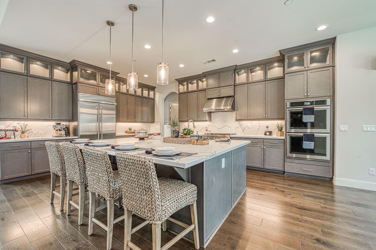 1632 North De Wolf Avenue Clovis, CA 93619 - Photo 38 of 80 a kitchen with stainless steel appliances kitchen island granite countertop a sink and cabinets