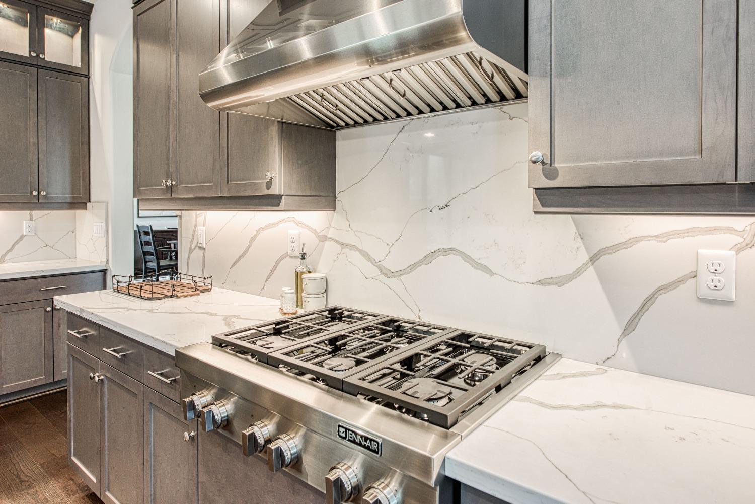 1632 North De Wolf Avenue Clovis, CA 93619 - Photo 40 of 80 a stove top oven sitting inside of a kitchen