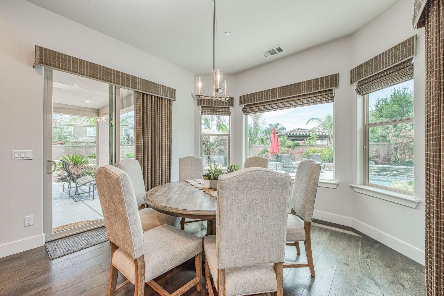 1632 North De Wolf Avenue Clovis, CA 93619 - Photo 43 of 80 a dining room with furniture large windows and wooden floor
