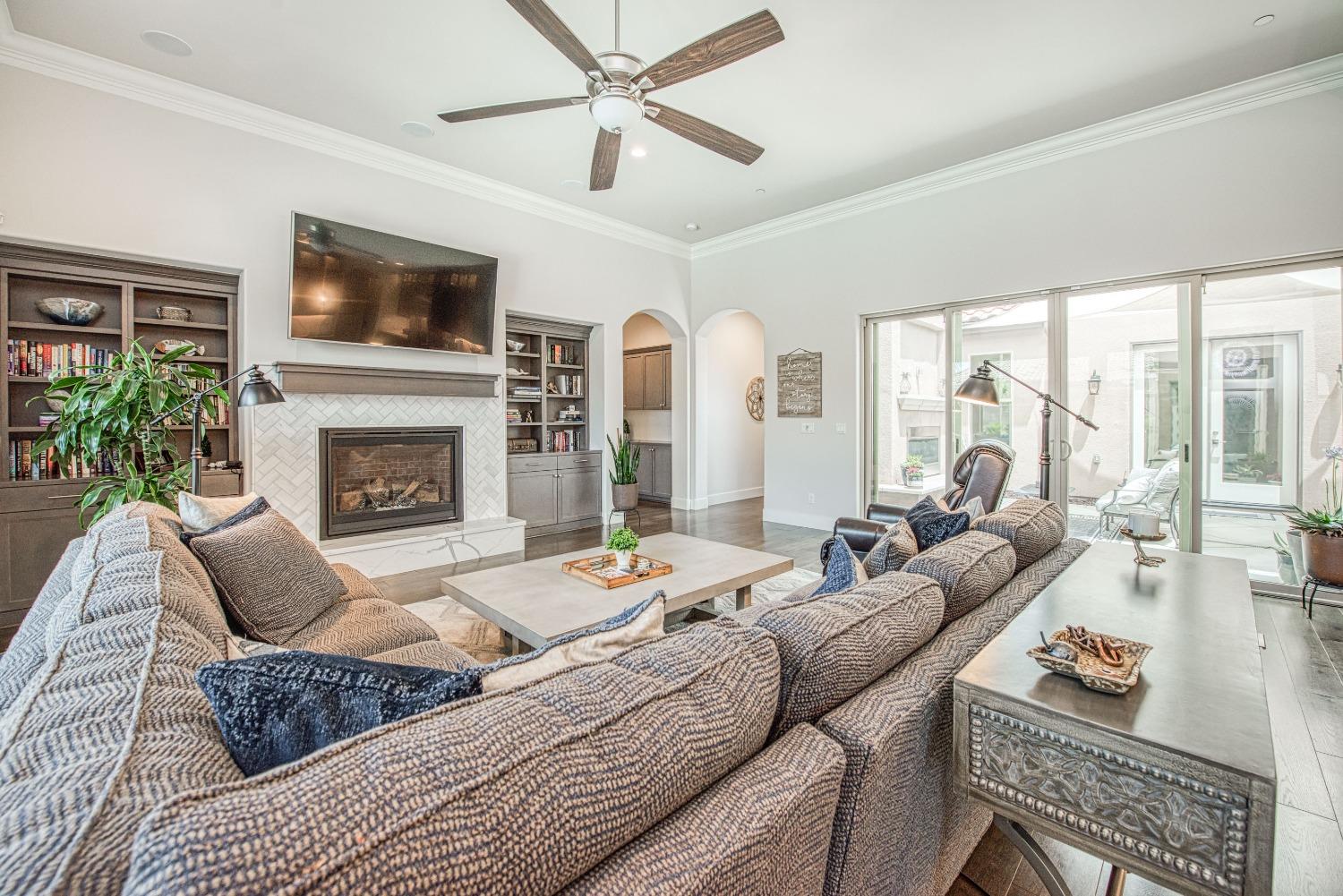 1632 North De Wolf Avenue Clovis, CA 93619 - Photo 45 of 80 a living room with furniture fireplace and a flat screen tv