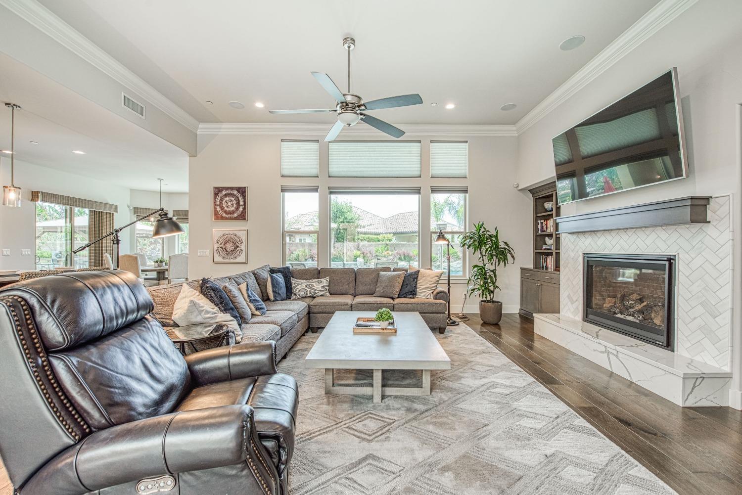 1632 North De Wolf Avenue Clovis, CA 93619 - Photo 46 of 80 a living room with furniture fireplace and flat screen tv