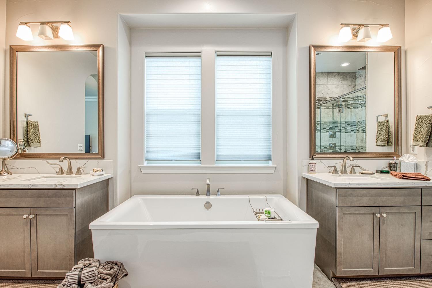 1632 North De Wolf Avenue Clovis, CA 93619 - Photo 56 of 80 a white bath tub sitting next to a white sink