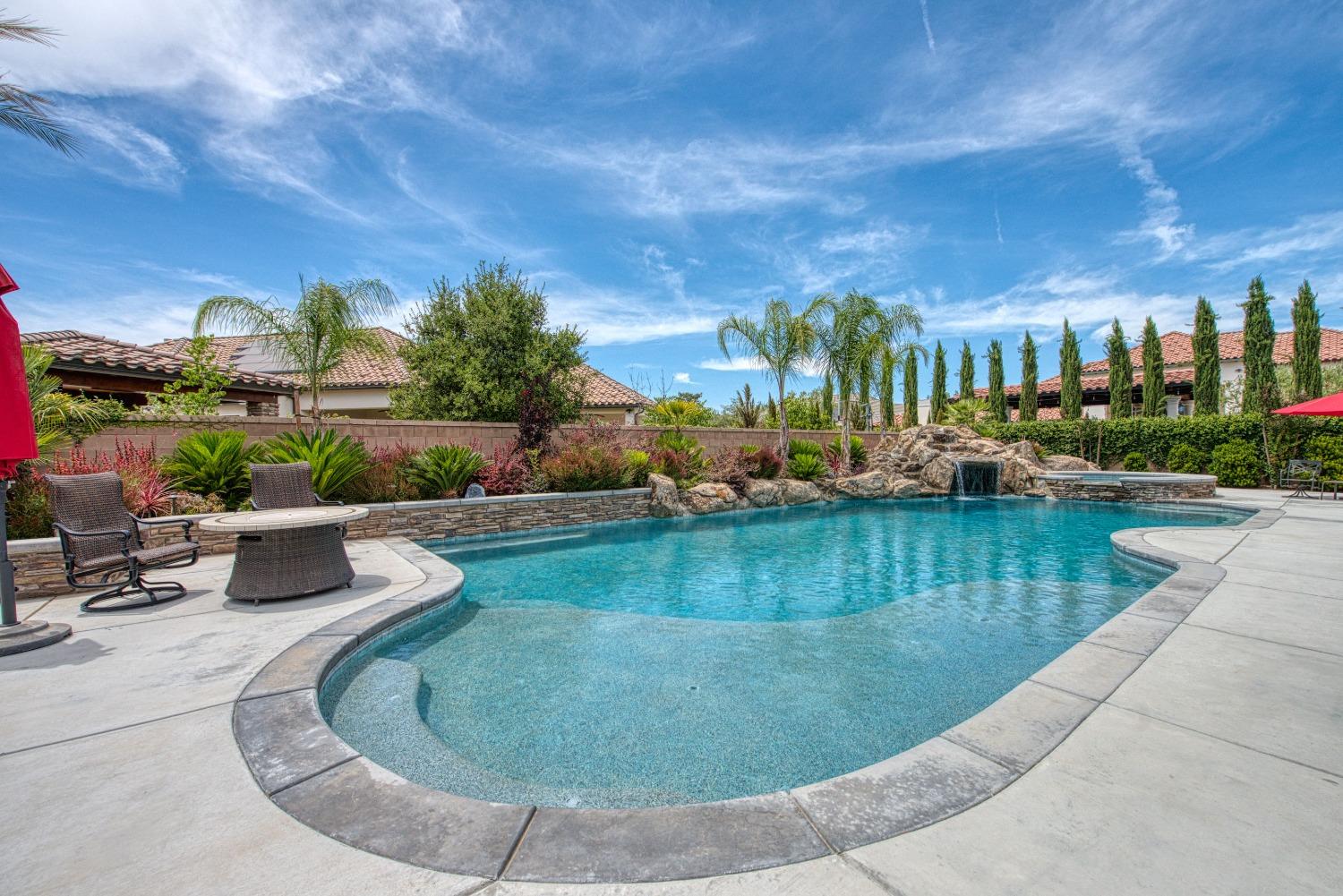 1632 North De Wolf Avenue Clovis, CA 93619 - Photo 61 of 80 a view of a swimming pool with outdoor seating and plants