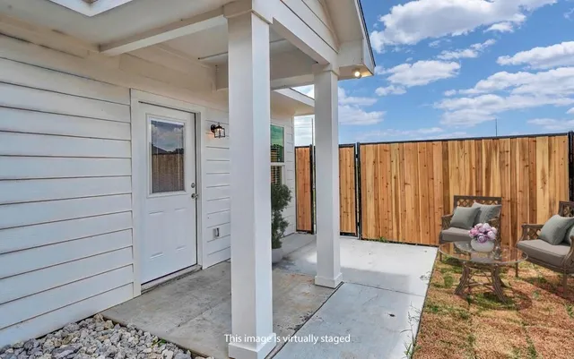a backyard of a house with table and chairs