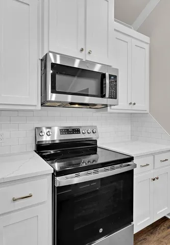 a stove top oven sitting inside of a kitchen