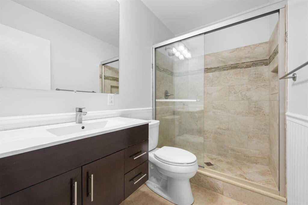 3801 Northeast 22nd Terrace, Unit 2 Lighthouse Point, FL 33064 - Photo 8 of 19 a bathroom with a sink and a mirror