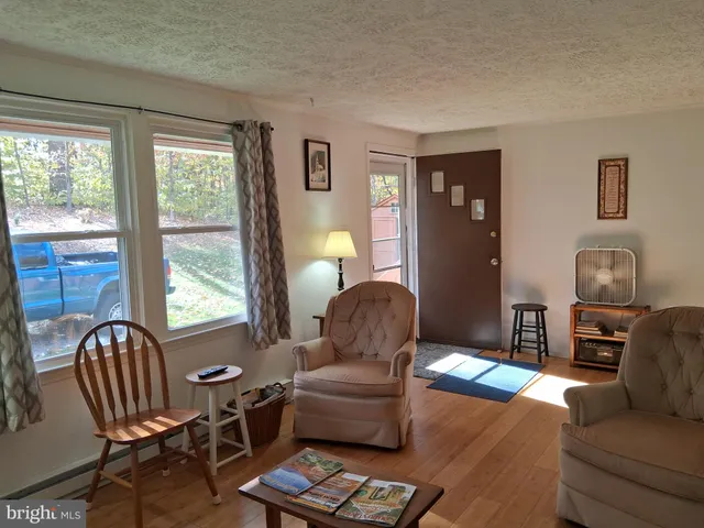 a living room with furniture and a lamp