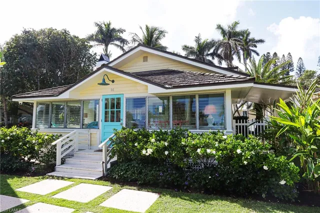 a front view of a house with a garden