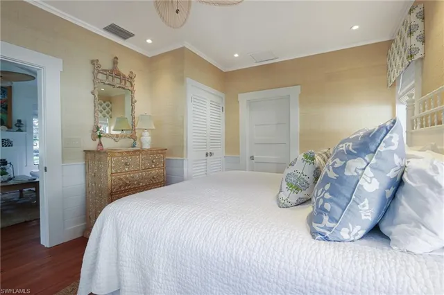 a bedroom with a bed and a dresser