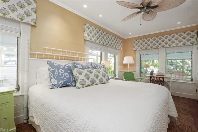 a large bedroom with a large bed and a chandelier