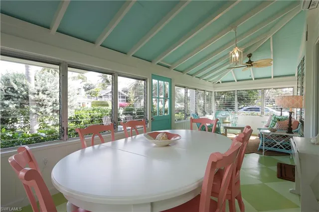a dining room with furniture window and outside view