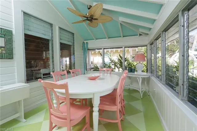 a dining room with furniture a rug and a large window