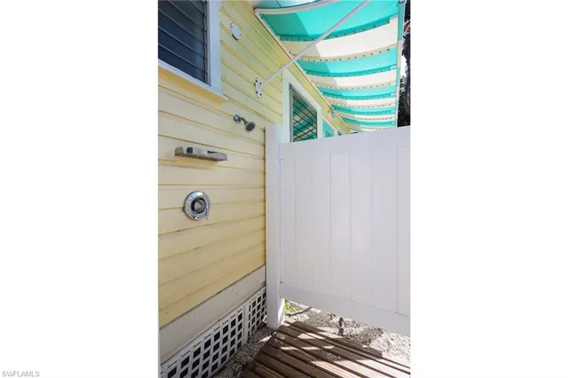 a view of a patio with table and chairs potted plants and palm tree
