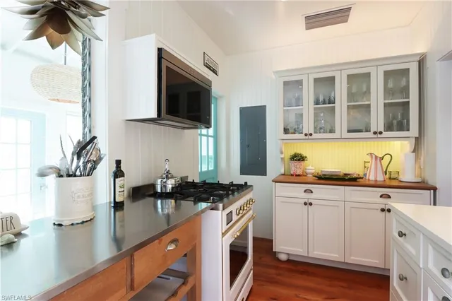 a kitchen with stainless steel appliances a sink stove and refrigerator